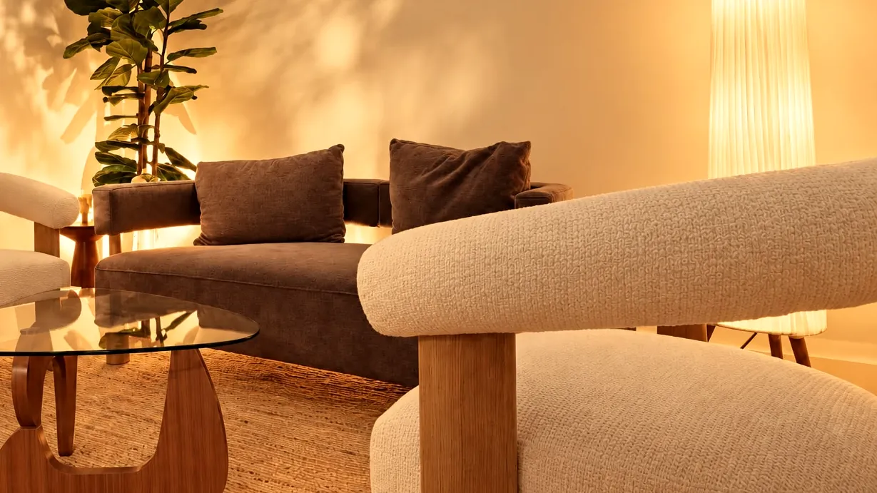 A quiet corner of the Millán Spa lounge in Miami Beach: a bouclé armchair, sofa and paper floor lamp