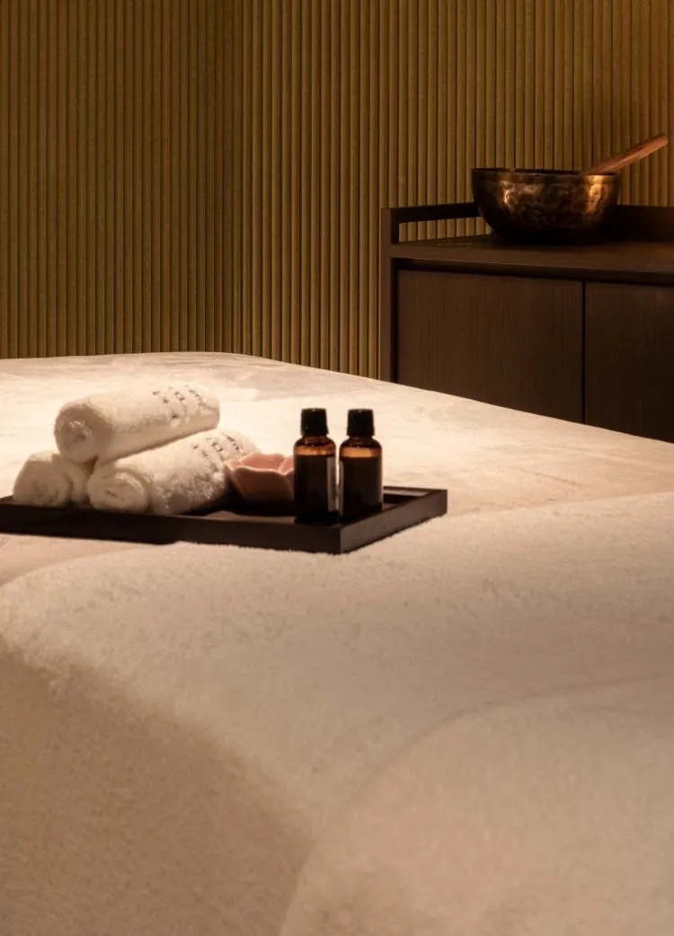 A treatment table with candles and oils at Millán Spa
